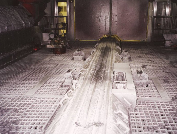 Industrial machine interior with metallic conveyor and large components.